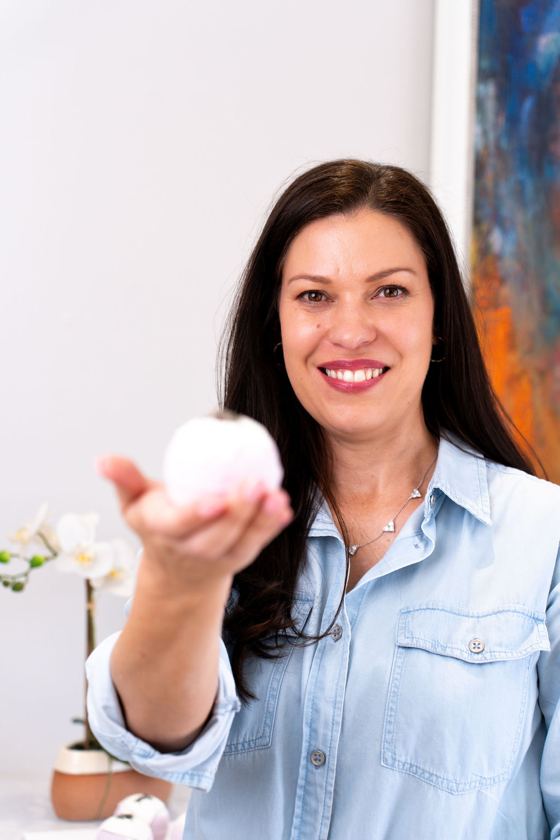 Colleen holding out a handmade bath bomb