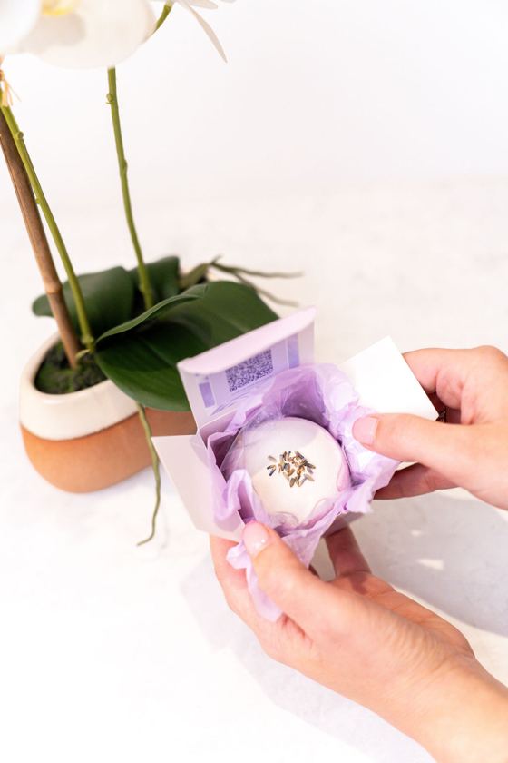 Unwrapping a lavender bath bomb from its box