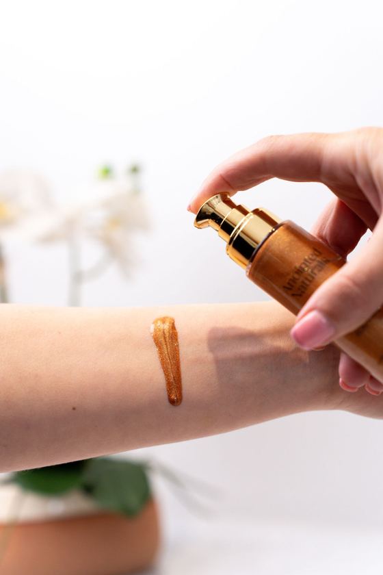 Shimmering body oil swatched on the wrist