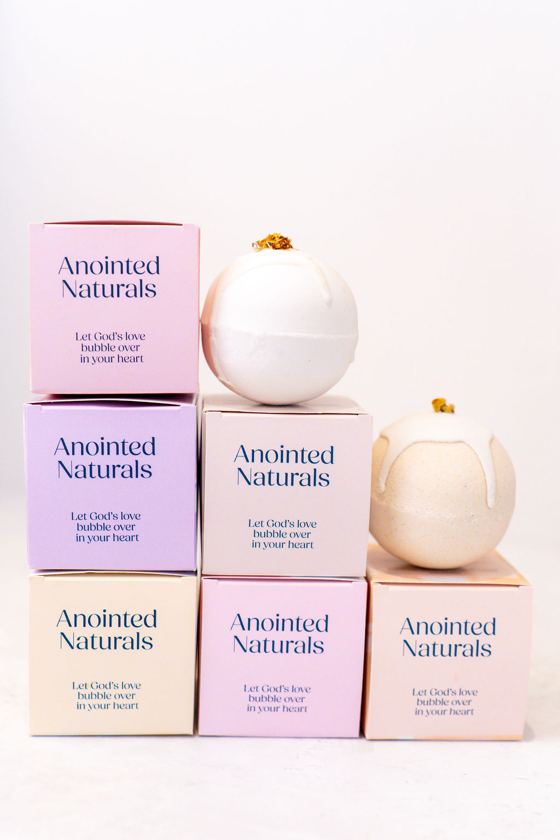 Bath bombs on a stack of Anointed Naturals boxes